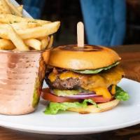 The Burger · 1/2 lbs Black Angus Beef Patty, Brioche Bun, Cheddar Cheese, Red Onions, Romaine Lettuce, To...