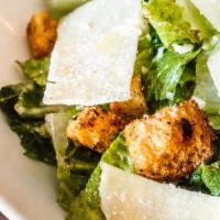 Caesar Salad · Romaine lettuce, house garlic herb croutons, Caesar dressing, shaved Parmesan cheese. no egg...