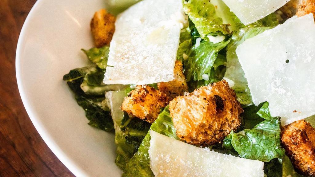 Caesar Salad · Romaine lettuce, house garlic herb croutons, Caesar dressing, shaved Parmesan cheese. no eggs, no anchovies.