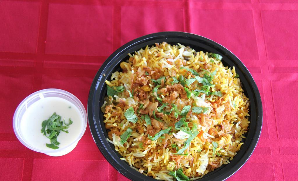 Veg Dum Biryani · Fresh Vegetables marinated and cooked with Spices , Basmati rice .It will be  served with Raita.