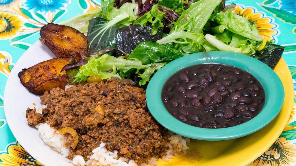 Picadillo Plate · stewed Niman Ranch ground beef with peppers, tomatoes, onions, spanish olives and raisins served with rice, black or pinto beans, plantains and organic salad