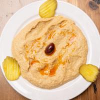 Hummus · Garbanzo beans mixed with tahini, lemon juice, garlic and a splash or virgin olive oil.