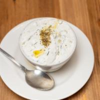 Cacik · Homemade cacik yogurt with diced cucumbers, oregano, fresh dill and hint of garlic.