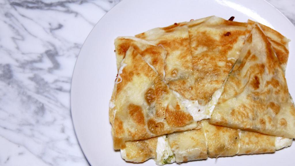 Regular Quesadilla · Two 7-inch flour tortillas stacked on each other with cheese filled in the middle.