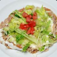 Tostada · Cheese, beans, sour cream, guacamole, lettuce & your choice of meat.