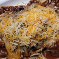 Chili Cheeseburger · Open faced, covered in chili and cheddar jack cheese, with onions on request.