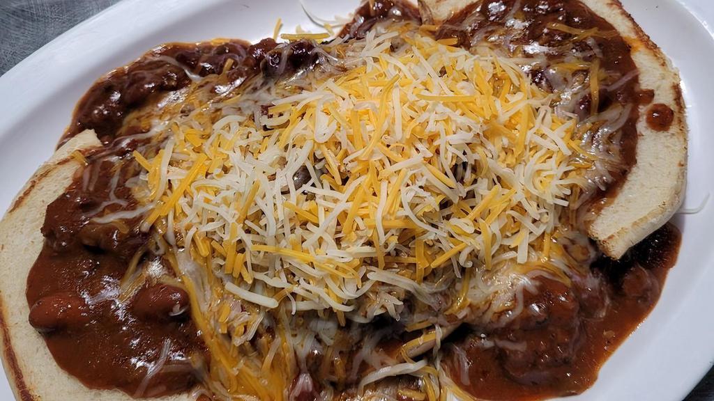 Chili Cheeseburger · Open faced, covered in chili and cheddar jack cheese, with onions on request.