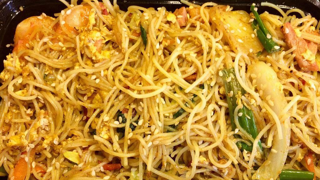 Singapore Style Noodles · Spicy. Singapore style rice noodle with B.B.Q. pork, shrimps, bean sprouts, carrots, other vegetables & egg in curry sauce.