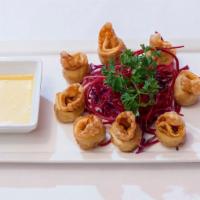 Crab Rangoon Rings · Crab meat and cream cheese wrapped in wonton skins, served with honey mustard.