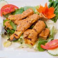 Chicken Satay Salad · Grilled chicken satay, crispy tofu, premium mixed greens, cucumber and tomatoes with peanut ...