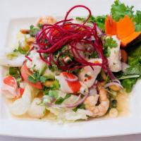 Seafood Salad · Prawns, calamari, scallops, fish and crab stick in fresh chili-lime dressing.
