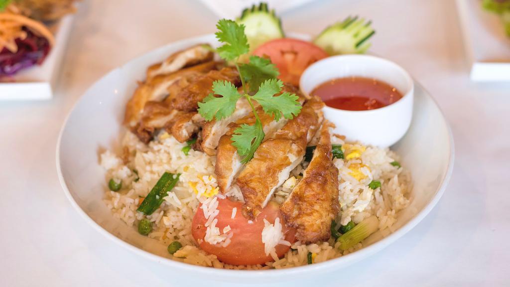 Fried Chicken over Fried Rice · Battered chicken breast, eggs, onions, scallions and tomatoes with sweet and sour dipping sauce.