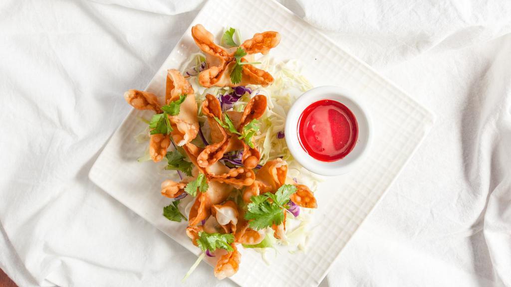 Crab Wontons · Deep fried wonton wrap stuffed with crab meat, cream cheese, red onions, and celery.
