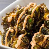 Cavolini al Grana Padano · Crispy Brussels sprouts drizzled with spicy peperoncino sauce