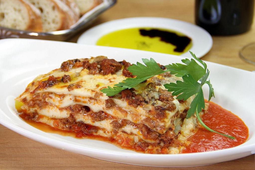 Lasagna Ferrarese · Pasta sheets, meat ragu, porcini mushrooms, grana padano, béchamel.