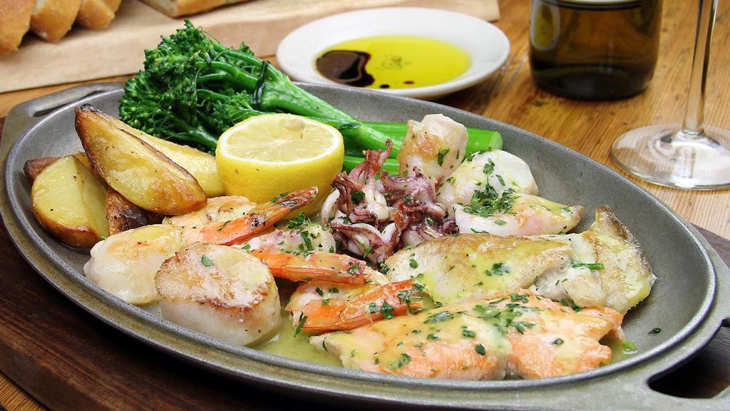 Grigliata di Pesce Misto* · mixed grill of fish fillet, scallops & prawns, topped with lemon-olive oil sauce; served with broccoli rabe & roasted yukon gold potatoes.