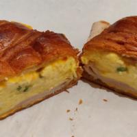 Breakfast Sandwich · Scrambled eggs with melted American cheese on croissant or bagel. Contain dairy, green onion...
