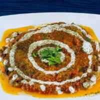 Banjan Borani · Fried eggplant cooked in our special house made masala sauce. Topped with yogurt and served ...