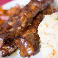 BBQ Pork Spareribs · Oven-baked for tenderness, then barbequed and topped with a light mopping of BBQ sauce.