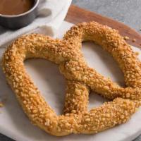 Sweet Almond Pretzel · A sweet yet salty pretzel baked fresh and topped with our own toasted almond crunch. Pair it...