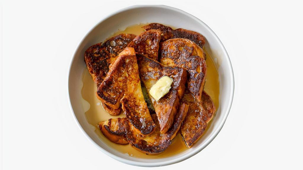 Classic French Toast · Two slices of bread dipped in egg, cream, cinnamon, and milk and grilled to perfection. Dusted with powdered sugar and syrup on the side.