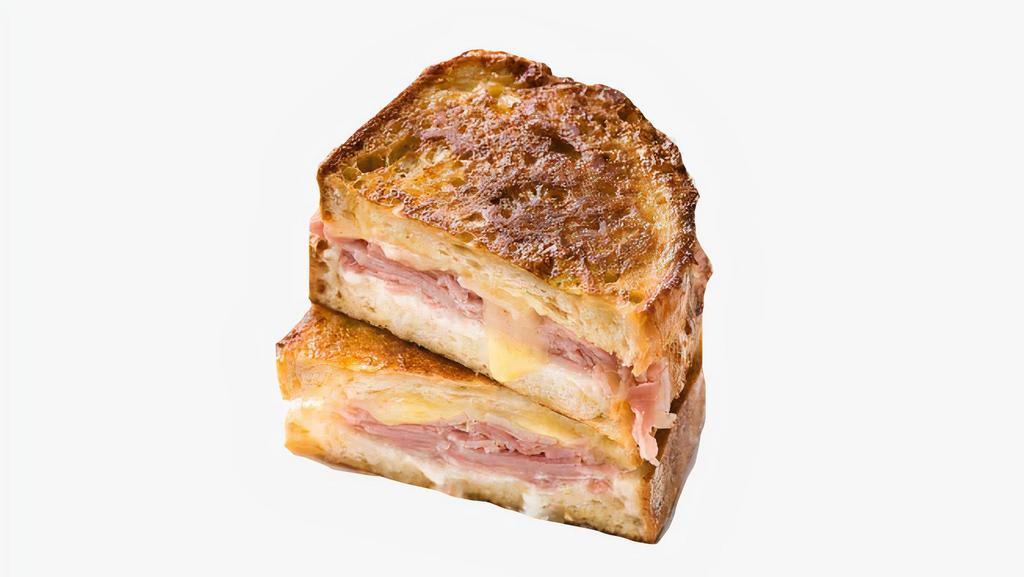 Ham, Egg, & Cheese French Toast Sandwich · Ham, fried egg, and Cheddar cheese sandwiched between two slices of classic French toast. Served with syrup on the side.