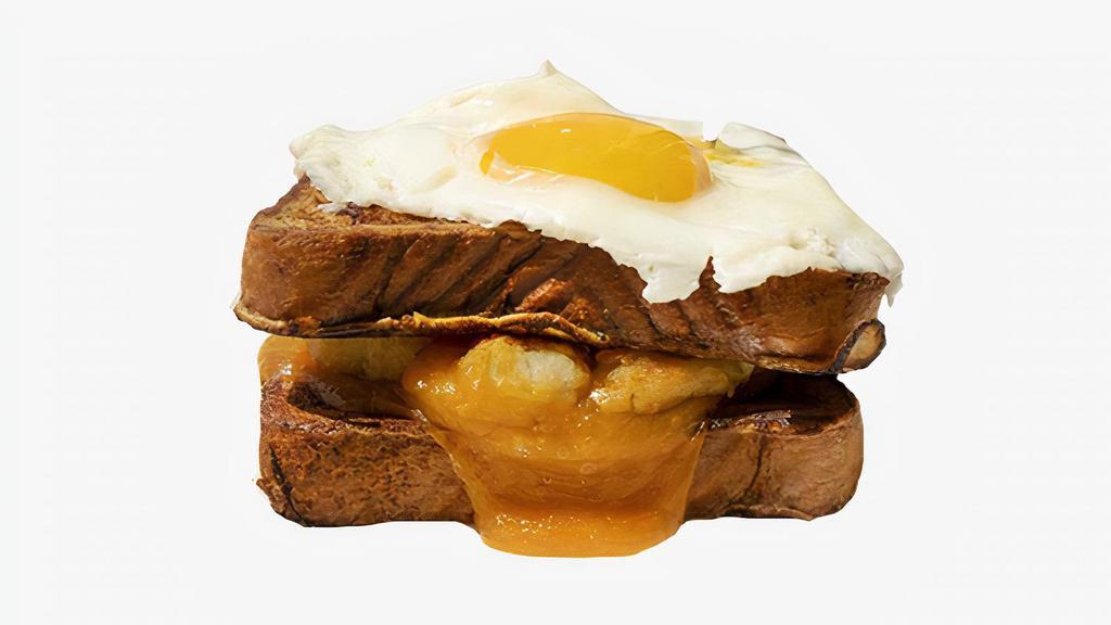 Potato, Egg & Cheese French Toast Sandwich · Potatoes, fried egg, and Cheddar cheese sandwiched between two slices of classic French toast. Served with syrup on the side.