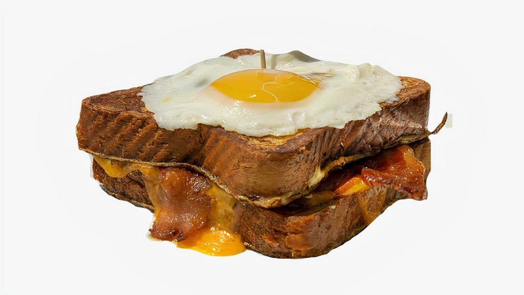 Bacon, Egg & Cheese French Toast Sandwich · Bacon, fried egg, and Cheddar cheese sandwiched between two slices of classic French toast. Served with syrup on the side.