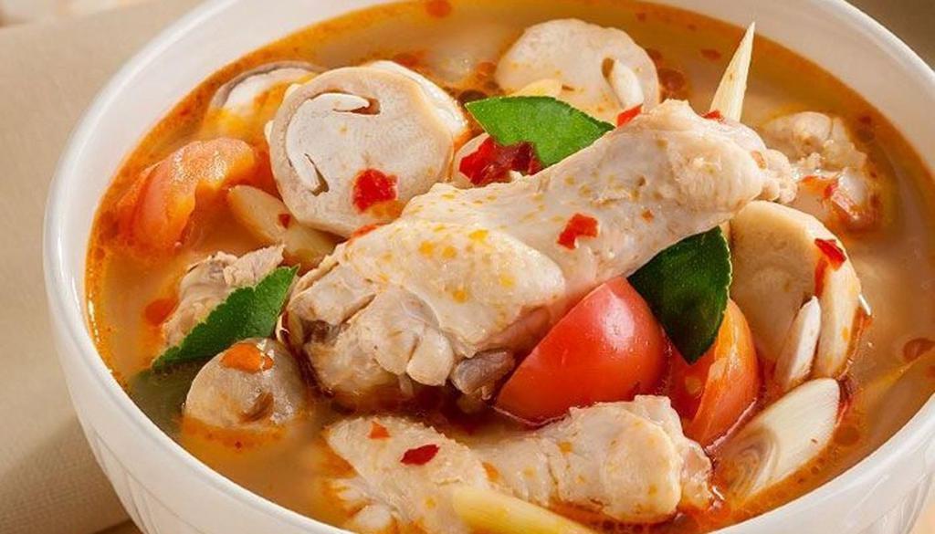 Tom Yum Chicken (S) · Spicy and sour chicken soup with assorted vegetables and herbs