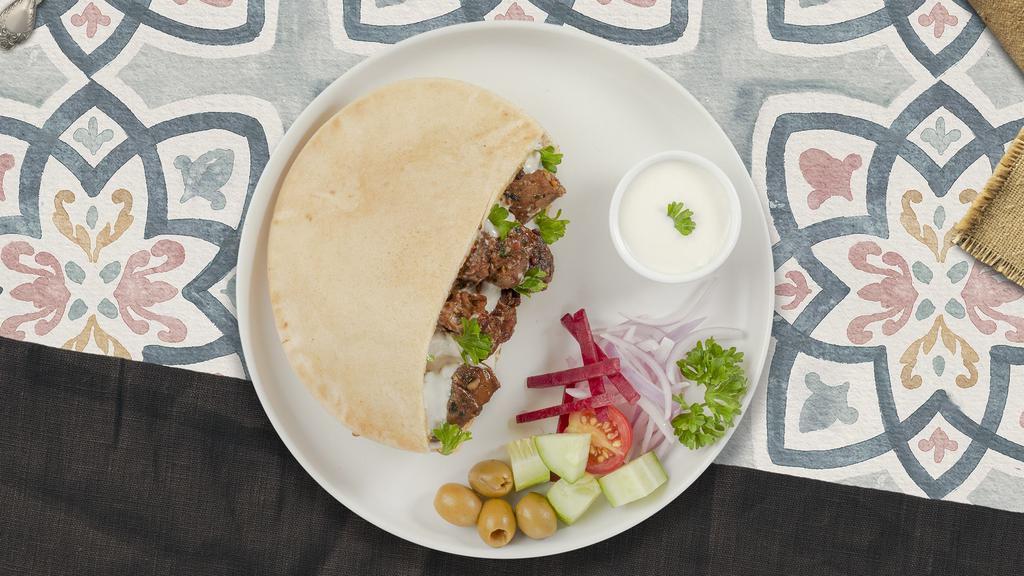 Lamb Shawarma Wrap  · Wrapped with lavash bread, hummus, babaganoush, salata and tahini sauce.