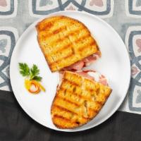 Turkey Panini  · Sliced turkey, melted cheese, and tomato on your choice of toasted bread.
