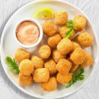 Tator Tots  · Shredded Idaho potatoes formed into tots, battered, and fried until golden brown. Served wit...