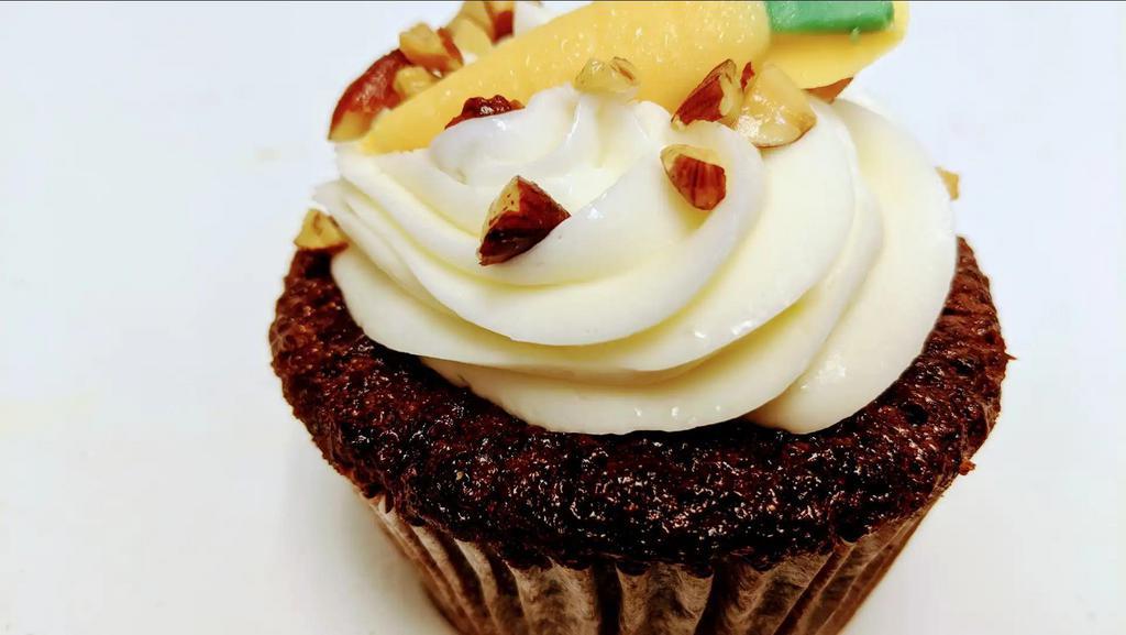 Yum Carrot Cake · Moist carrot cake topped with luscious cream cheese frosting . Depending on availability the cake may be a cup cake or sliced cake.