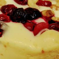 Merry Cranberry Walnut Cheesecake · Cream cheese cake topped with Cranberries and Walnuts.