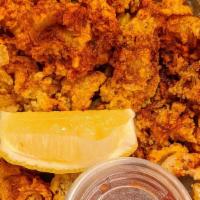 Fried Calamari · Breaded and fried, tossed in spices served with cocktail sauce.