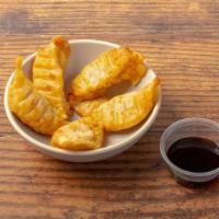 Chicken Gyoza · Crispy dumplings filled with minced chicken. Served with our gyoza dipping sauce. Contains g...