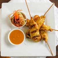 5. Chicken Satay · Grilled marinated sliced chicken breast on skewers. Served with cucumber salad and peanut sa...