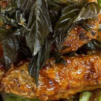 6. Spicy Wing · Deep-fried chicken wing until crispy. Topped with chili-garlic sauce and crispy basil.