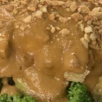 67. Pra-Ram · Sautéed with garlic and topped with peanut sauce; served on a bed of steamed vegetable.