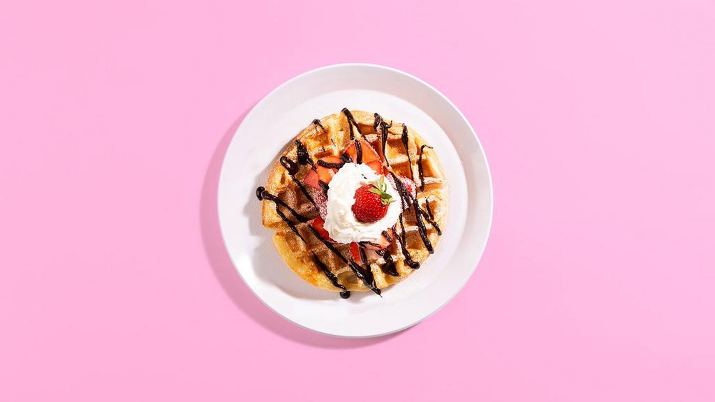 Strawberry Chocolate Waffle · A fluffy Belgian waffle drizzled with chocolate sauce and topped with strawberries, maple syrup, and whipped cream.