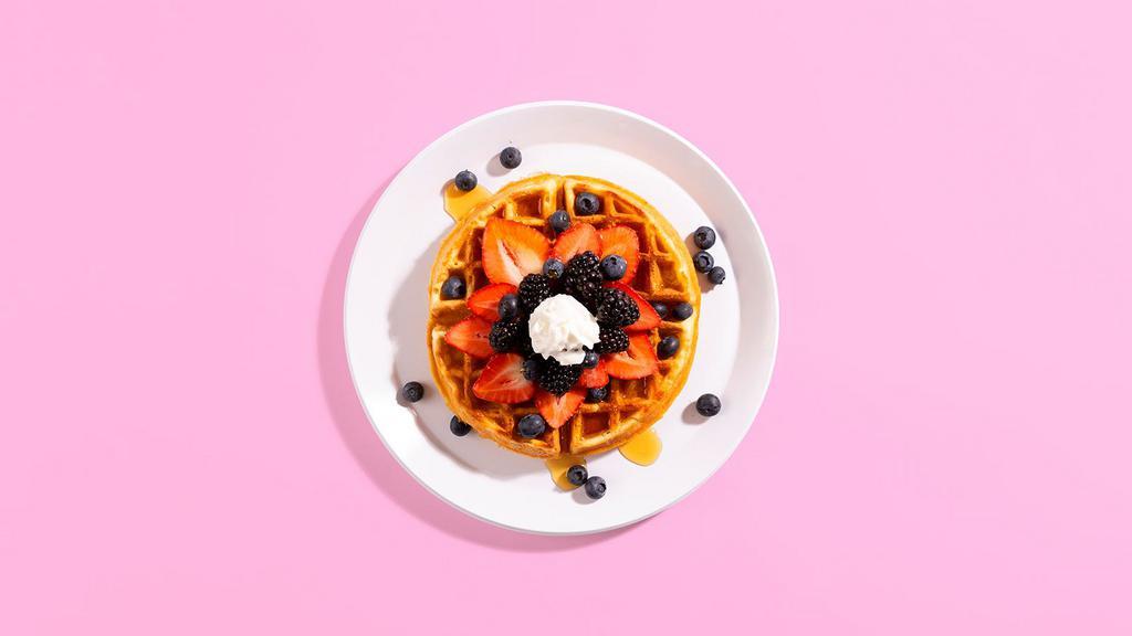 Mixed Berry Waffle · A fluffy Belgian waffle loaded with fresh blueberries and strawberries, and topped with a chocolate drizzle and whipped cream.
