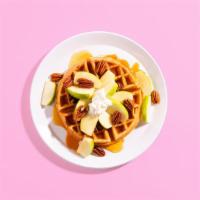 Caramel Apple Waffle · A fluffy Belgian waffle covered in sliced apples and toasted pecans, and topped with rich ca...