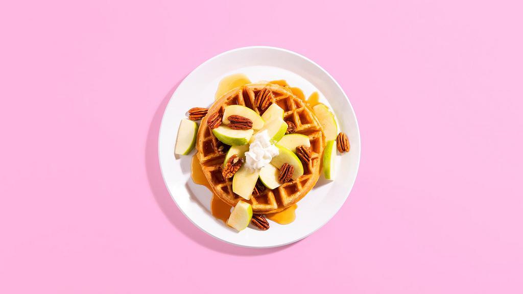 Caramel Apple Waffle · A fluffy Belgian waffle covered in sliced apples and toasted pecans, and topped with rich caramel sauce and whipped cream.