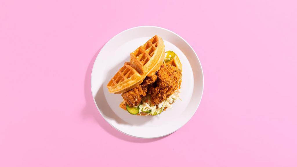 Fried Chicken and Waffle Sandwich · Crispy fried chicken with coleslaw, pickles, and mayo sandwiched between two fluffy Belgian waffles.