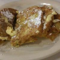 Sourdough French Toast · 3 slices of sourdough French toast with powder sugar served with butter & syrup.