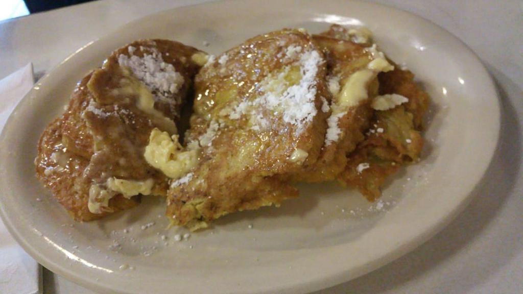 Sourdough French Toast · 3 slices of sourdough French toast with powder sugar served with butter & syrup.