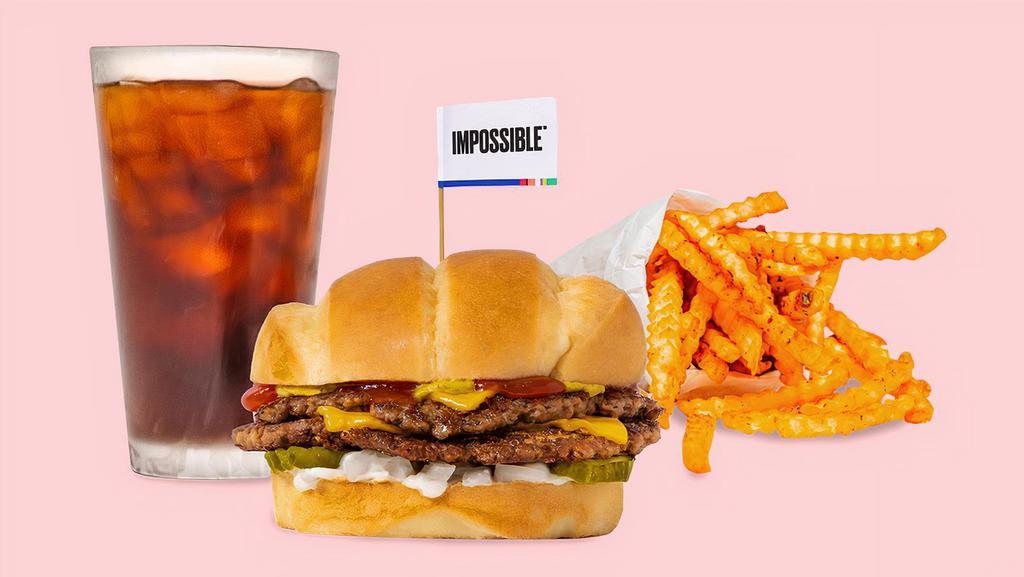 Impossible™️ Beast Style Burger Combo · Smashed crispy Impossible™ patties with house seasoning, American cheese, pickles, diced white onion, mayo, ketchup, and brown mustard on a soft roll served with your choice of seasoned or Beast style fries and a drink.
