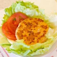 Lettuce Salmon Wrap · No bun. Salmon patty with tomatoes, onions and dressing. Served wrapped in lettuce.