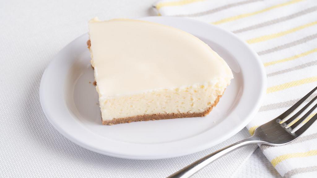 Cheesecake Pie Plain (Slice) · A cheesecake pie made with real Philadelphia cream cheese in hand pressed graham cracker crust.