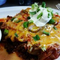 Huevos Rancheros · Fried corn tortilla topped with chorizo, black beans, olives, onions, tomatoes, cheddar and ...